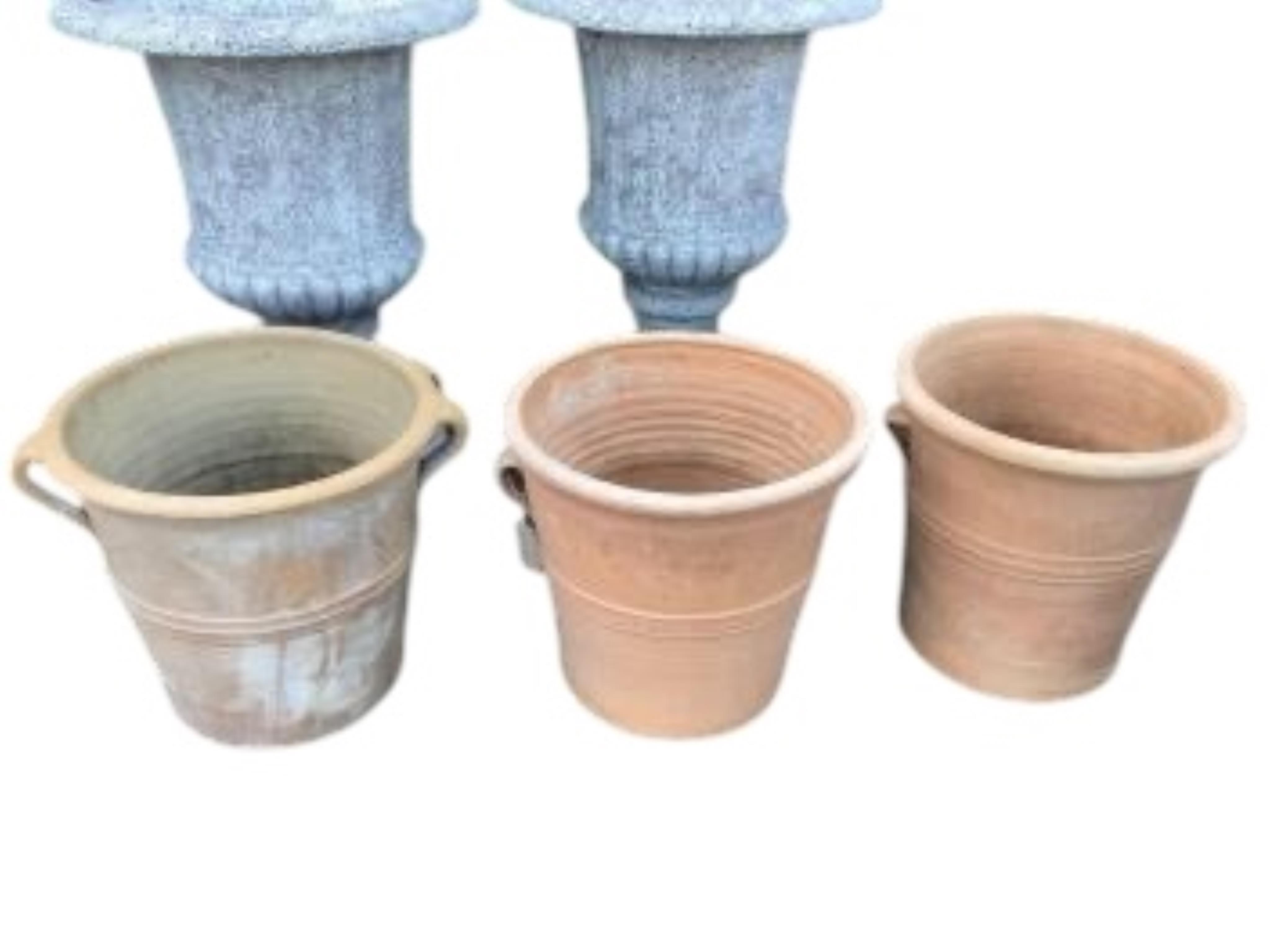Three circular terracotta garden planters, diameter 41cm, height 38cm